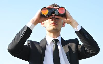 Man searching horizon with binoculars